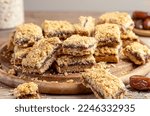 Small photo of Homemade old fashioned date squares or Matrimonial bars on wooden cutting board with ingredients