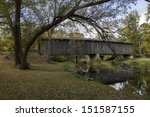 Photograph of a historical covered bridge crossing a southern Wisconsin river near Cedarburg.