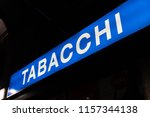 Small photo of Blue signage of a Tabacchi, Italian for Tobacco shop, on a black background. Also called a tobacco shop, a tobacconist's shop or a smoke shop, it is a retailer of tobacco products