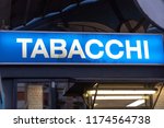 Small photo of Blue signage of a Tabacchi, Italian for Tobacco shop, on a black background. Also called a tobacco shop, a tobacconist's shop or a smoke shop, it is a retailer of tobacco products