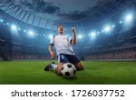 Small photo of Soccer player celebrates a victory on the professional stadium . Stadium and crowd are made in 3D.