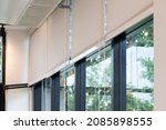 white curtain or white blinds Roller sun protection in office with garden view background.