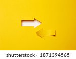 Two opposite left-right arrows, one cutted from the yellow paper curved up of two sides on the yellow paper background other made as an arrow shaped hole in the background with white paper underlay