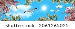 Small photo of Panoramic sky view. Pink, white spring flowers and birds flying in a sunny sky. sky background with seagulls. flowery sky bottom view