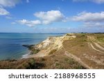View of coastline in southern England. Scenic view from on top cliff looking out to sea. Hampshire coastline with eroded cliff on beach