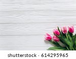 Pink tulips on a white wooden background for Mother's Day