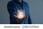 Small photo of Businessman hold smartphone with online shopping concept, marketplace website with virtual interface of online Shopping cart part of the network, Online shopping business with selecting shopping cart.