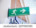 Small photo of exit sign in red and white color signifies a way out or emergency exit. It is an essential safety feature in public and commercial buildings, providing clear and visible guidance to people
