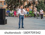 Small photo of Dnipro, Ukraine - August 21, 2020: Middle-aged man Prygunov Glib in national costume speaks into microphone on central square of the city