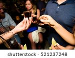 Small photo of People clang shots with drinks