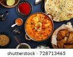 Indian cuisine on diwali holiday: tikka masala, samosa, patties and sweets with mint chutney and spices. Dark blue background