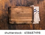Old Cutting Board with cloth napkin on a old wooden table, top view