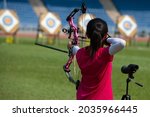 Little girl shoot at archery...