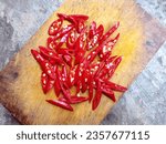 The red chilies that have been cleaned are then sliced ​​and placed on a cutting board. Top view.
