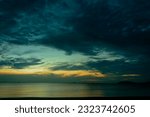 Sea view, bright blue morning sky with dark black and white clouds and deep blue ocean on a day, feel calm, cool, relax, idea for use as a modern background image.