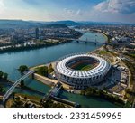 Small photo of Budapest, Hungary - 07.10.2023 - Aerial view of Budapest on a sunny summer day, including National Athletics Centre, Rakoczi bridge, Kopaszi gat and MOL Campus building at background with blue sky