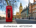 London, England - The iconic british old red telephone box with the Big Ben at background in the center of London
