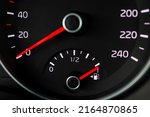 Close up of a fuel gauge showing a full fuel tank in a car, transportation with fossil fuel, efficiency of modern vehicles