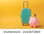 Small photo of Travel.Vacation money saving concept,piggy bank beach vacation.Miniature luggage and bundles of hundred dollar bills.Vacations.Copy space.Savings concept for vacation.
