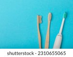 Small photo of Electric and manual toothbrushes on a blue background. View from above. Oral hygiene. Ordinary toothbrush, eco and electric toothbrush. Oral hygiene. Oral Care Kit. Dentist concept. Dental care.