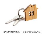 House keys with house shaped keychain, isolated on white background
