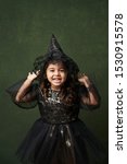 Cute child girl in witch...