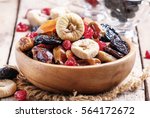 Healthy food: mix from dried fruits in bowl, old wooden background, selective focus