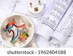Electrical box with connections of electric copper wires, plug and housing plan. Components using in electrical installations. Accessories for engineering work