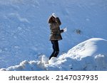 Child Playing Snowball In Snow. ...