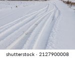 Snowy Road In A Field Leading...