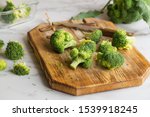 Fresh green broccoli on a wooden cutting board. Macro photo green fresh vegetable broccoli. Green Vegetables for diet and healthy eating. Organic food preparation. Natural kitchen