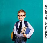 Small photo of Book, school, kid. Diligent, sedulous, studious student holding books. Cheerful smiling little kid with big backpack against chalkboard. Looking at camera. School concept. Back to School