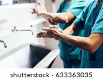 Couple of Surgeons Washing Hands Before Operating. Hospital Concept.