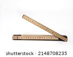 Close up of wood material wooden meter stick folding rule with one segment opened on white background