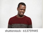 Small photo of Negative human facial expressions, emotions and feelings. Portrait of squeamish disgusted young African American male looking in terror and contempt, feeling loathing and disgust towards something