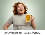 Funny young Caucasian male feeling happy and relaxed, anticipating fresh cold beer in his hands after hard working day, closing eyes in enjoyment. Bearded overweight redhead man drinking lager