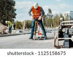 Worker In Reflective Vest With...