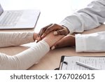 Small photo of African female doctor holding hand supporting caucasian woman patient. Kind ethnic professional physician give empathy concept encourage reassure infertile patient at medical visit, close up view.
