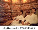 Portrait of young couple in salt inhalation steam room, relaxing.