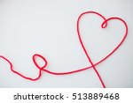handicraft, love, valentines day, healthcare and needlework concept - red knitting yarn thread in shape of heart