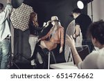 Fashion stylist with professional model at photoshoot backstage