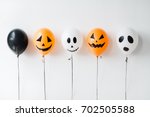 holidays, decoration and party concept - scary air balloons for halloween over white background
