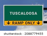 Tuscaloosa logo. Tuscaloosa lettering on a road sign. Signpost at entrance to Tuscaloosa, USA. Green pointer in American style. Road sign in the United States of America. Sky in background