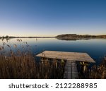 Small photo of wooden gangplank at a small lake after a winter night