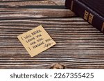 Small photo of I will never leave you nor will I forsake you-God, handwritten verse on note with holy bible on wooden table. Jesus Christ's promise, love, and care, biblical concept.