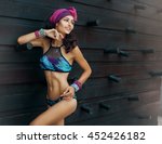 Fashion photo of beautiful tanned woman with perfect body and hair in bikini posing in sunny day over the wall.Sensual young girl enjoying vacation on luxury villa. Colorful filter,tan skin tone