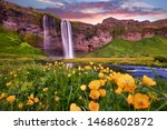 Incredible sunset on Seljalandsfoss. One of the most beautiful waterfalls on the Iceland, Europe. Popular and famous tourist attraction summer holiday destination in on South Iceland. Travel postcard