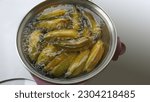Small photo of Ripe bananas are boiled in boiling water in an electric frying pan