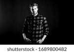 Small photo of Barbershop and beauty salon. Hipster black background. Standards of manliness or masculinity. Handsome well groomed man in checkered shirt. Manliness concept. Meaning of modern manliness. Male beauty