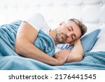 mature man having siesta in bed. early morning